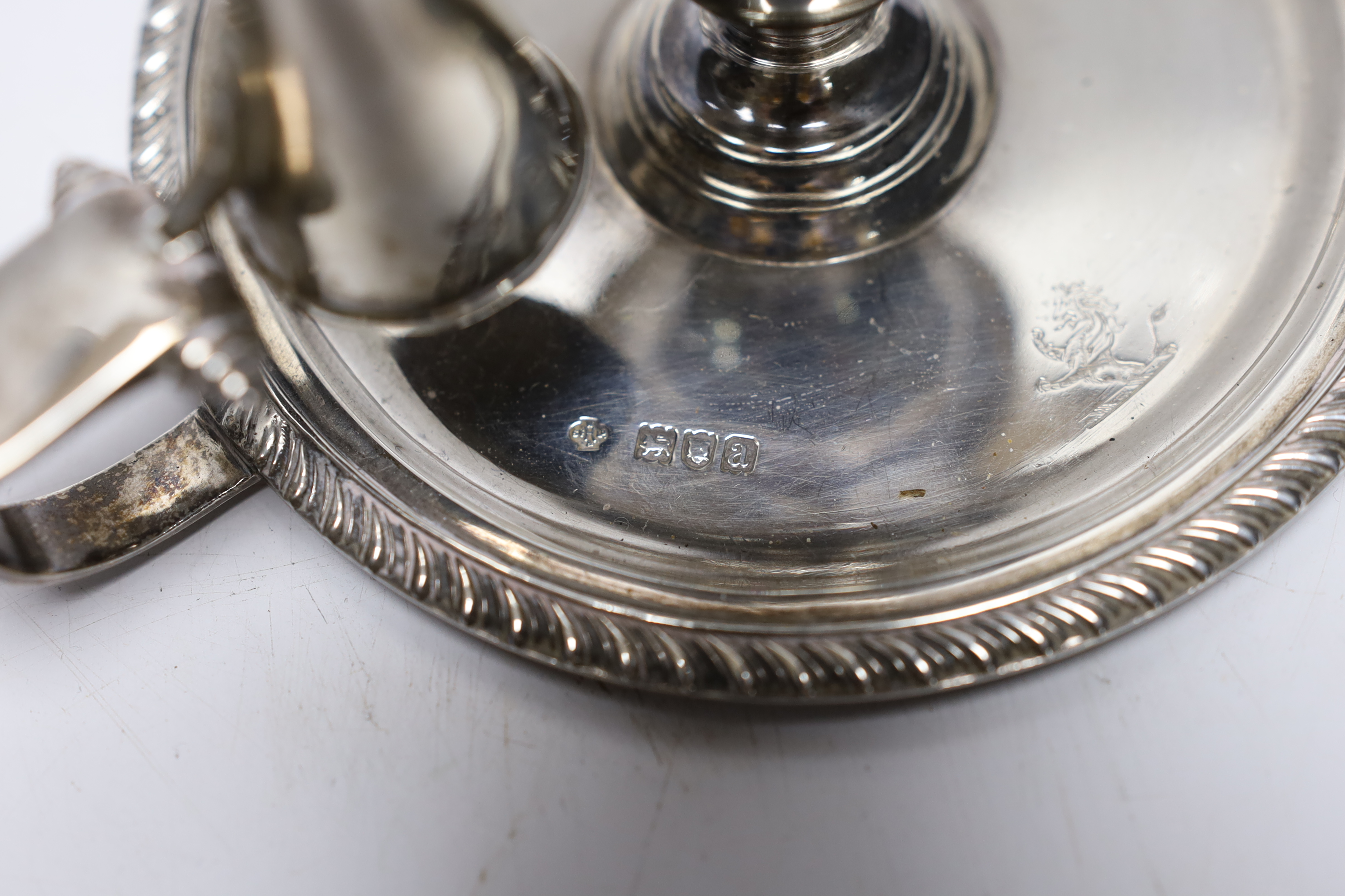 A pair of late Victorian silver chambersticks, with gadrooned borders and matching extinguishers, William Hutton & Sons, London, 1896, base diameter 13.2cm, 18.3oz.